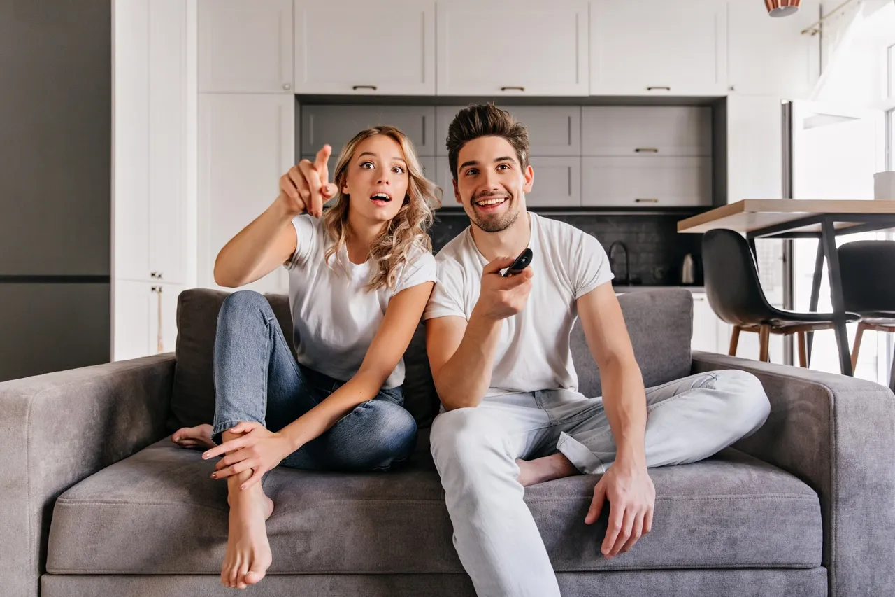 Couple watching IPTV on Smart TV at home